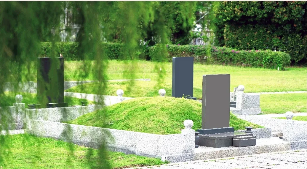 Landscaped burial plots framed by willow trees and greenery at Nirvana Shah Alam