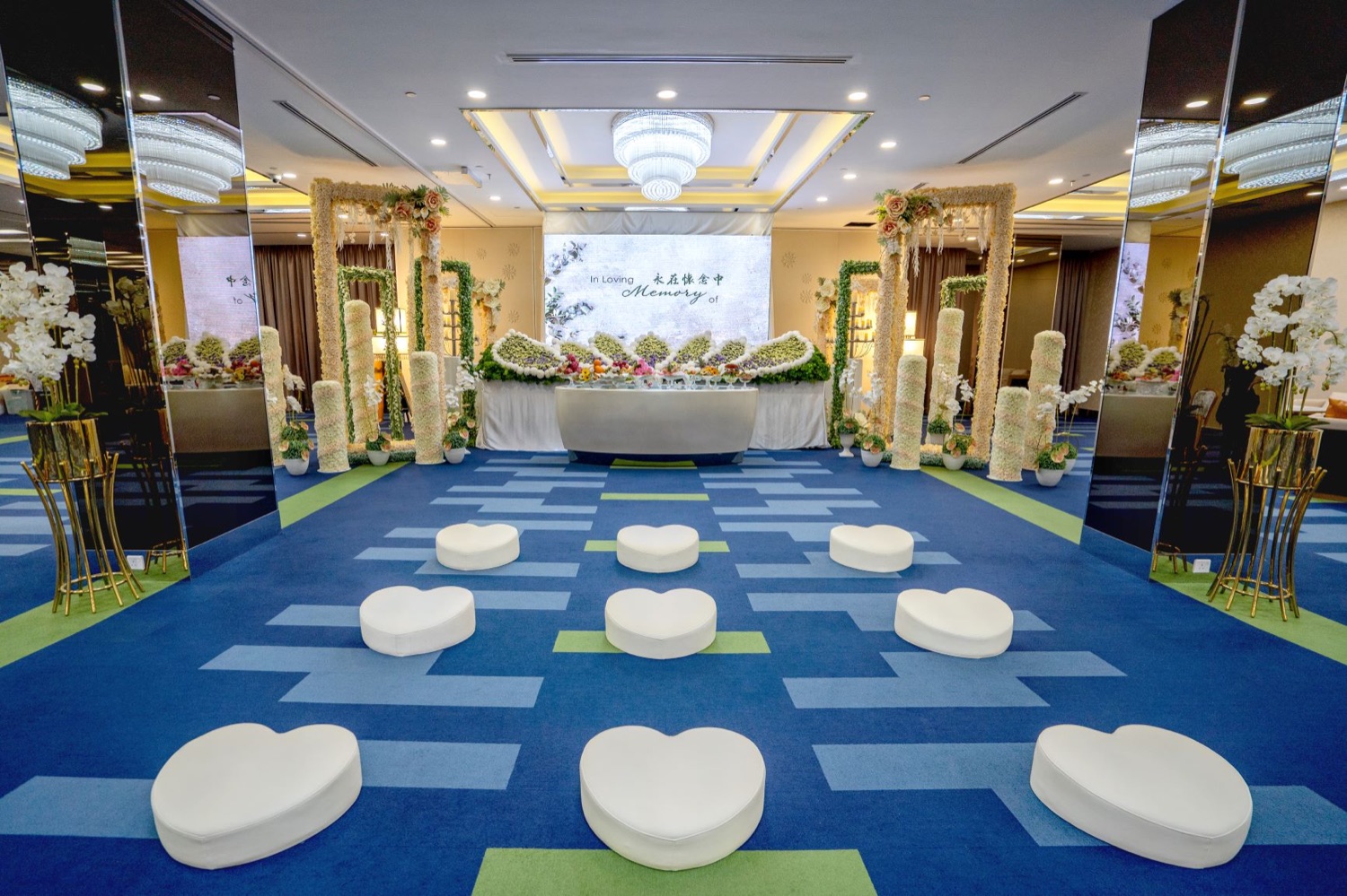 Memorial ceremony setting with floral arrangements and a remembrance display